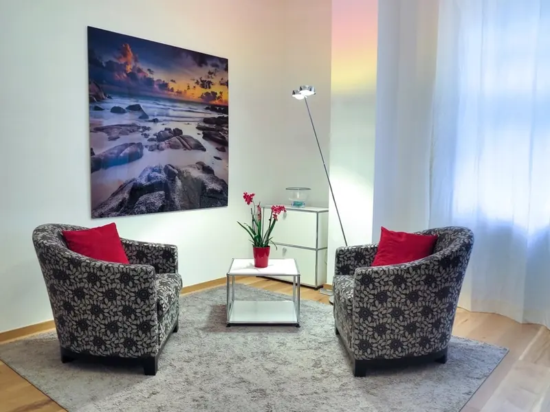 A quiet consultation room with two armchairs and a small table